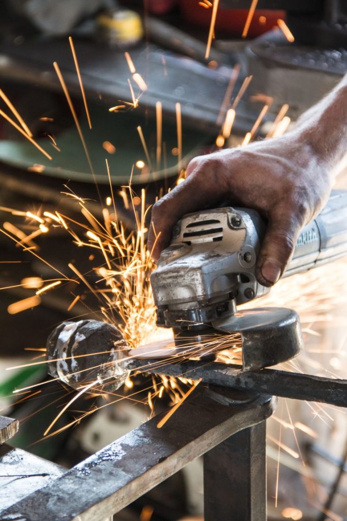 Michael Hart working with a grinder in Horsmonden Forge