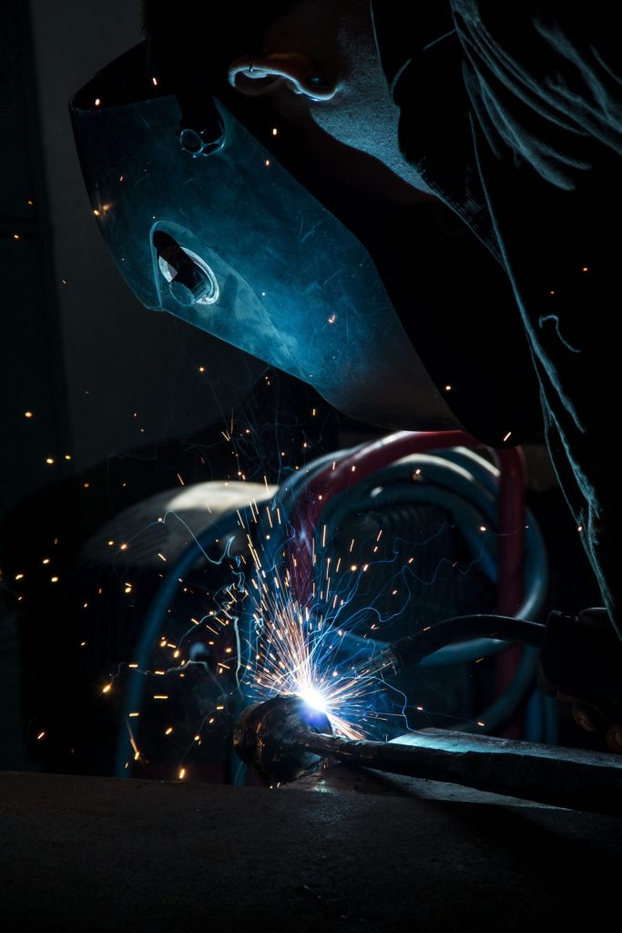 Michael Hart working in Horsmonden Forge with mask